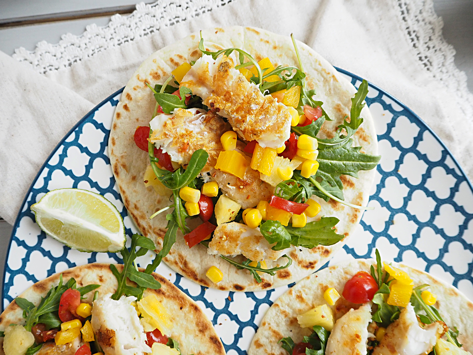 A close up of some fish tacos with pineapple salsa