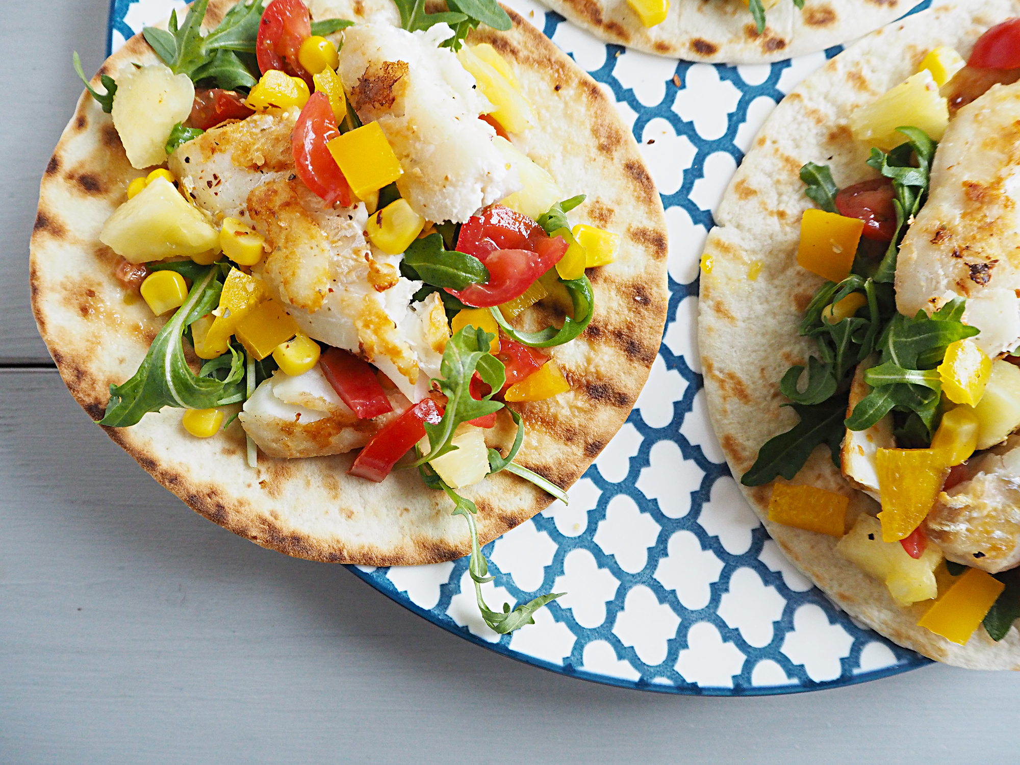 A close up of some fish tacos with pineapple salsa