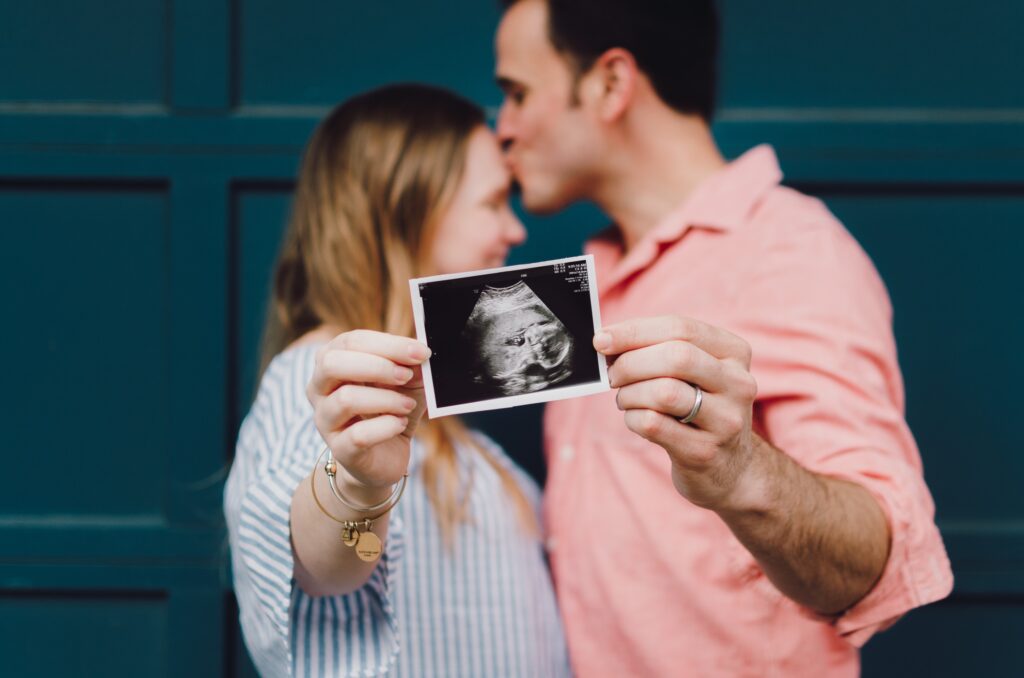 A couple recognizing their baby's ultrasound photo during early pregnancy.