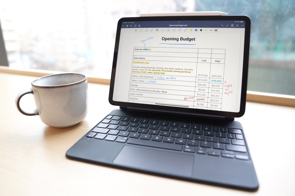 An Auto Draft tablet computer with a cup of coffee next to it.
