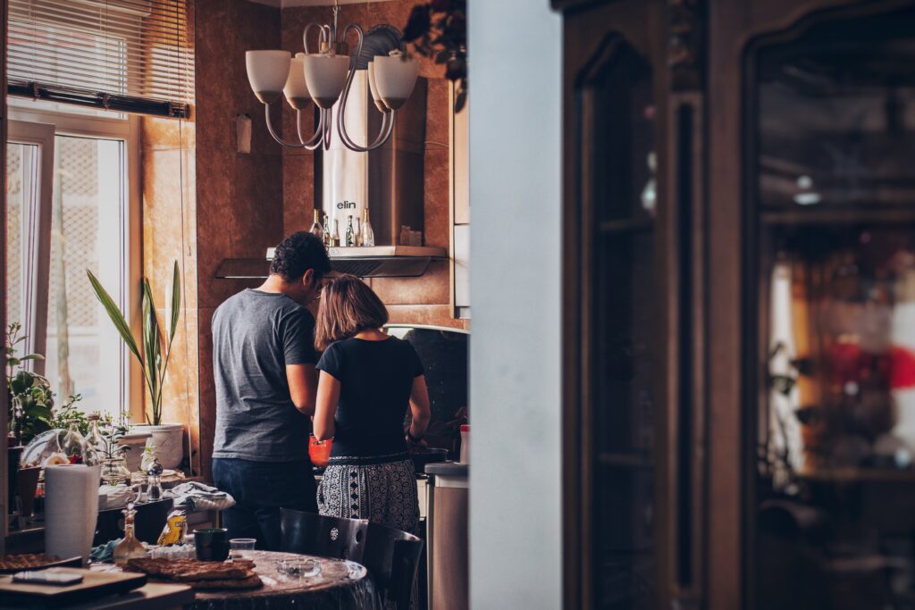 A man and woman, professionals, standing in a kitchen.