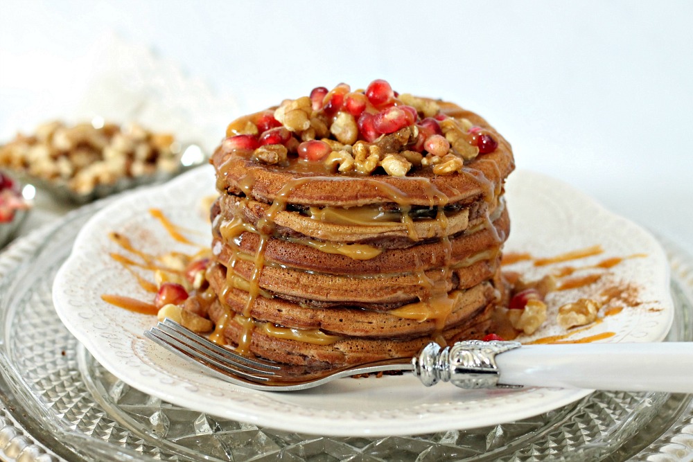 cinnamon caramel cake batter pancakes stacked on a plate 