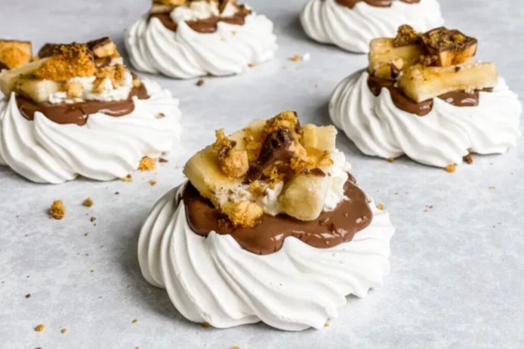 individual meringue nests topped with crunchie, chocolate and banana