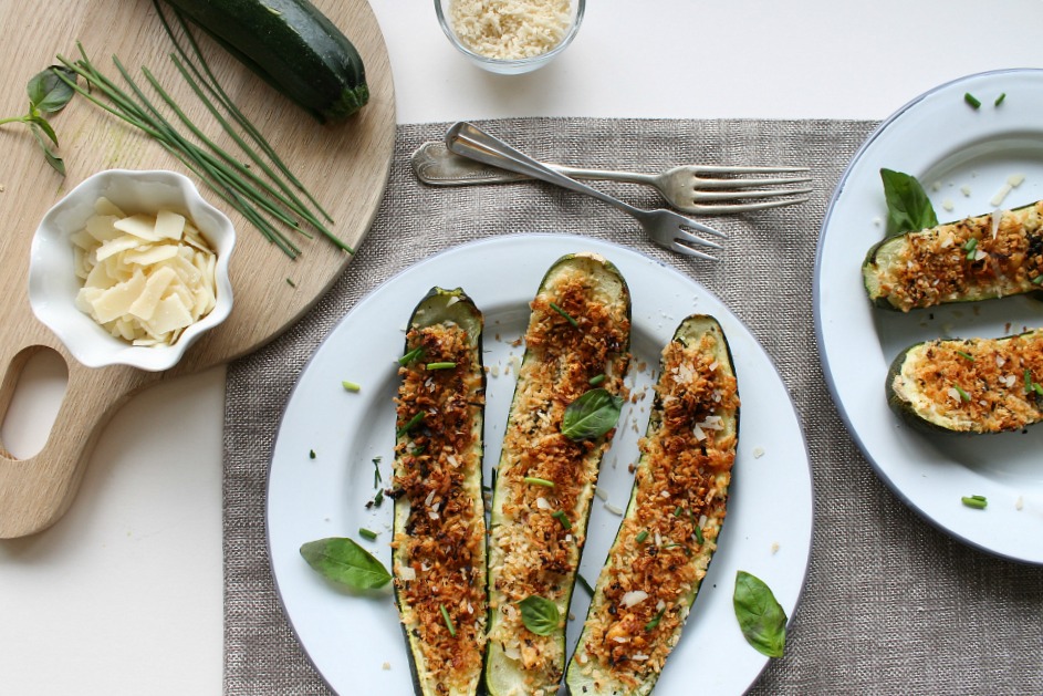 Parmesan Stuffed Courgettes on a white plate, set on a table