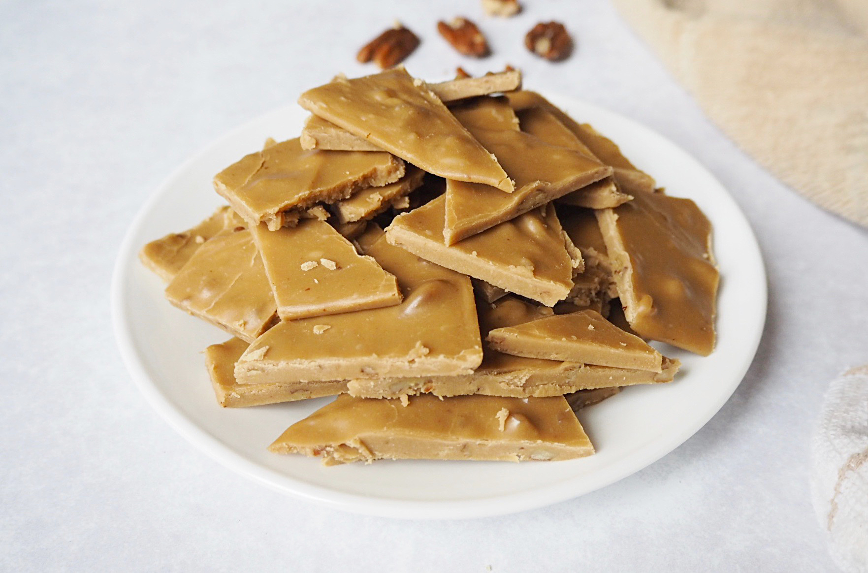 A pile of caramel frosting snacks on a white plate