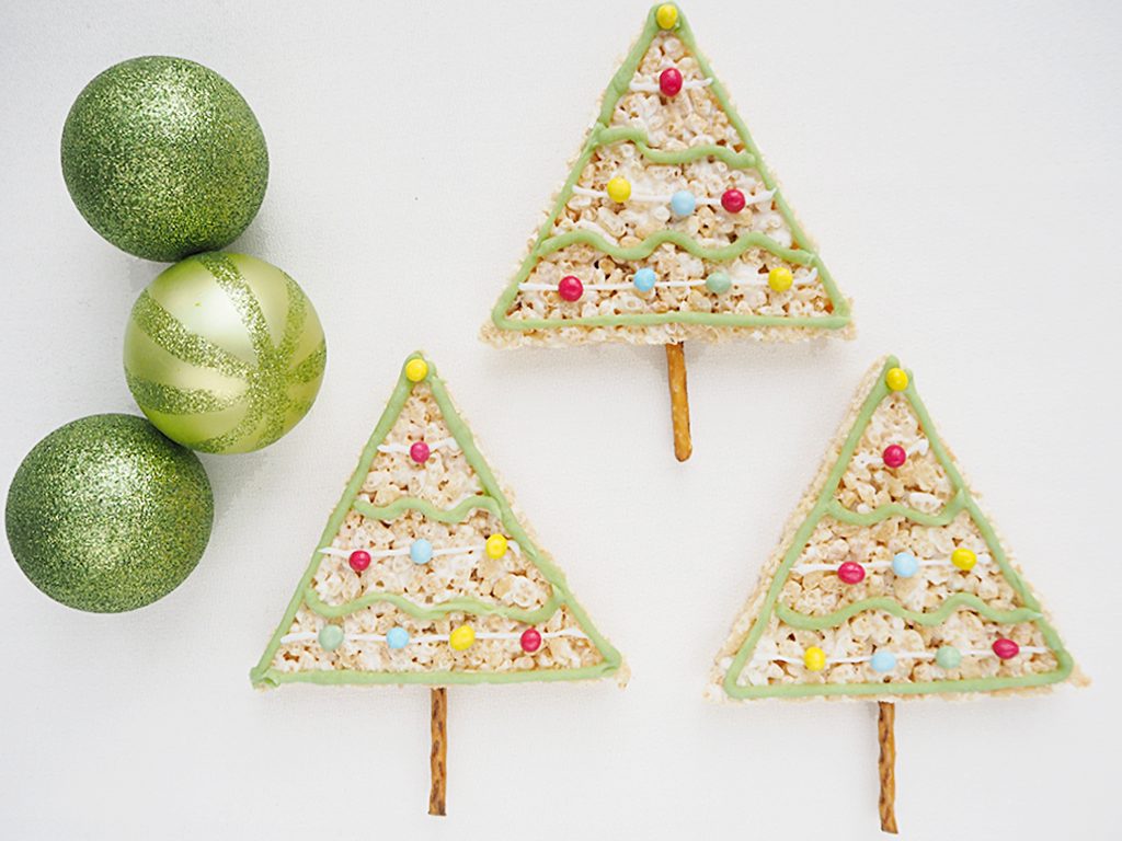 Rice Krispy Treats Christmas Trees with pretzel trunks with 3 glittery green Christmas baubles