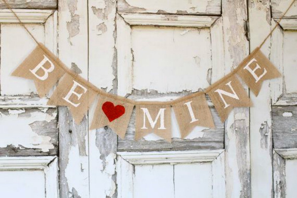 A garland with "Be Mine" written on it and a red heart
